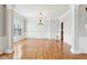 Open-concept living room with large windows, chandelier and decorative trim at 3932 Long Ridge Blvd, Carmel, IN 46074