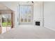 Light-filled living room featuring a fireplace, vaulted ceilings, and expansive windows at 3932 Long Ridge Blvd, Carmel, IN 46074