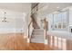 Open-concept living area with staircase, hardwood floors, and large windows at 3932 Long Ridge Blvd, Carmel, IN 46074