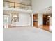 Open concept living area with hardwood floors, kitchen and staircase to 2nd floor at 3932 Long Ridge Blvd, Carmel, IN 46074