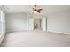 Spacious main bedroom features a ceiling fan, carpet, and entrance to hallway at 3932 Long Ridge Blvd, Carmel, IN 46074