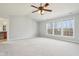 Spacious main bedroom features a ceiling fan, carpet, and large windows at 3932 Long Ridge Blvd, Carmel, IN 46074