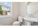 Charming powder room with modern fixtures, pedestal sink, toilet, and window at 3932 Long Ridge Blvd, Carmel, IN 46074