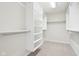 Organized walk-in closet with built-in shelving and hanging rods at 3932 Long Ridge Blvd, Carmel, IN 46074