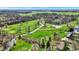 Overhead view showcasing property near a golf course with creek, ponds and mature trees at 3991 Clubhouse Dr, Greenfield, IN 46140