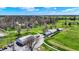 Aerial view showcasing the golf course and clubhouse situated amongst mature trees at 3991 Clubhouse Dr, Greenfield, IN 46140