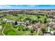 Aerial view showcasing property's proximity to golf course with tree-lined fairways and putting greens at 3991 Clubhouse Dr, Greenfield, IN 46140