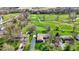 Scenic aerial view of home on lush golf course with mature trees and green lawn at 3991 Clubhouse Dr, Greenfield, IN 46140