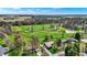 Beautiful aerial view of property backing onto a golf course, mature trees, and lush greenery at 3991 Clubhouse Dr, Greenfield, IN 46140