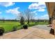 Beautiful backyard with expansive view, patio, mature trees and blue skies at 3991 Clubhouse Dr, Greenfield, IN 46140