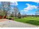 Expansive backyard with lush green grass, mature trees, and an unobstructed view of the golf course at 3991 Clubhouse Dr, Greenfield, IN 46140