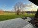Expansive backyard featuring a patio, manicured lawn, mature trees, and decorative landscaping at 3991 Clubhouse Dr, Greenfield, IN 46140