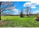 Lush backyard features a well-manicured lawn and beautiful scenery at 3991 Clubhouse Dr, Greenfield, IN 46140