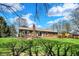 Spacious backyard showcasing a brick home with a well-manicured lawn and mature trees at 3991 Clubhouse Dr, Greenfield, IN 46140
