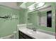 Stylish mint green bathroom featuring an elegant vanity and tub-shower combination at 3991 Clubhouse Dr, Greenfield, IN 46140
