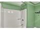 Clean and simple white tub-shower combination in a renovated bathroom at 3991 Clubhouse Dr, Greenfield, IN 46140