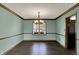 This dining room features wood floors, neutral walls, modern lighting, and ample natural light at 3991 Clubhouse Dr, Greenfield, IN 46140
