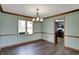 A charming dining room showcases wood floors, light walls, modern lighting, and kitchen access at 3991 Clubhouse Dr, Greenfield, IN 46140