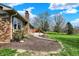 Charming brick home with stone pathway, showcasing its backyard and mature landscaping at 3991 Clubhouse Dr, Greenfield, IN 46140