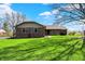 Inviting ranch home featuring brick facade, lush green lawn, and mature trees in a bright exterior shot at 3991 Clubhouse Dr, Greenfield, IN 46140