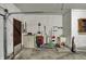 Well-organized corner of a three-car garage with storage solutions for tools and cleaning equipment at 3991 Clubhouse Dr, Greenfield, IN 46140