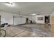 Spacious three car garage with smooth concrete floor and bright overhead lighting at 3991 Clubhouse Dr, Greenfield, IN 46140