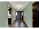 Inviting hallway with wood floors leading to the front door, complemented by neutral walls and classic light fixture at 3991 Clubhouse Dr, Greenfield, IN 46140