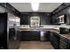 Charming kitchen with stainless steel appliances, dark cabinets, and unique wall accents and decor at 3991 Clubhouse Dr, Greenfield, IN 46140