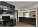 The kitchen features stainless appliances, dark cabinetry, countertops, and a view into the Gathering room at 3991 Clubhouse Dr, Greenfield, IN 46140