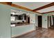 A view of the kitchen with dark cabinetry and countertops, with an open view into the living room at 3991 Clubhouse Dr, Greenfield, IN 46140