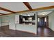 View of the kitchen from the dining area, featuring dark cabinets and countertops, and an open plan at 3991 Clubhouse Dr, Greenfield, IN 46140