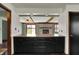 View of kitchen cabinets and countertop with an opening looking into the living room with a brick fireplace at 3991 Clubhouse Dr, Greenfield, IN 46140
