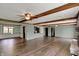 Spacious living room showcasing hardwood floors, beamed ceilings, fireplace and a window providing natural light at 3991 Clubhouse Dr, Greenfield, IN 46140