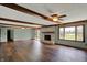 Open floor plan featuring wood floors, brick fireplace, wood beams and slider doors for natural lighting at 3991 Clubhouse Dr, Greenfield, IN 46140