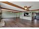Open living room with hardwood floors, brick fireplace, beamed ceilings and a view into the kitchen at 3991 Clubhouse Dr, Greenfield, IN 46140