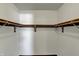 Empty walk-in closet featuring built-in wooden shelving and ample storage space at 3991 Clubhouse Dr, Greenfield, IN 46140