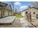 Inviting backyard features a stone patio, lush lawn, and a charming fence; ideal for outdoor entertaining and relaxing at 40 N Ritter Ave, Indianapolis, IN 46219