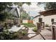 Beautiful backyard features a firepit, landscaped garden beds, stepping stones and a wooden deck at 40 N Ritter Ave, Indianapolis, IN 46219