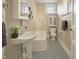 Charming bathroom with blue tiled floor, vanity sink, bathtub, toilet, and stylish decor at 40 N Ritter Ave, Indianapolis, IN 46219