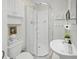 Bright bathroom featuring a glass corner shower, toilet, and sink with stylish decor at 40 N Ritter Ave, Indianapolis, IN 46219