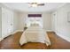 Traditional bedroom featuring hardwood floors, neutral walls, a ceiling fan, and natural light through a window at 40 N Ritter Ave, Indianapolis, IN 46219