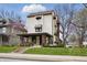 Charming two-story home with a brick-accented porch, awning-covered windows, and well-maintained lawn at 40 N Ritter Ave, Indianapolis, IN 46219