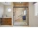 Bathroom featuring a glass shower with built-in seat and grab bar, plus an unique octagon-shaped window at 40 N Ritter Ave, Indianapolis, IN 46219