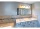 Bathroom featuring double sinks with white cabinets and decorative mosaic tile at 416 Concord Way, Greenwood, IN 46142