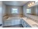 Relaxing bathroom featuring a soaking tub, mosaic tiles, and double sink vanity at 416 Concord Way, Greenwood, IN 46142