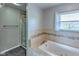 Bathroom with a jetted tub, tiled surround, and walk-in shower at 416 Concord Way, Greenwood, IN 46142