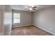 Neutral-toned bedroom featuring a ceiling fan, window with blinds, and plush carpeting at 416 Concord Way, Greenwood, IN 46142