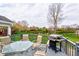 Outdoor deck with a table, chairs, and grill overlooking a serene pond at 416 Concord Way, Greenwood, IN 46142