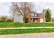 Two-story home featuring brick and gray siding, a covered front porch, and an attached garage at 416 Concord Way, Greenwood, IN 46142