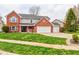 Charming two-story home with brick facade, attached two-car garage, and well-manicured lawn at 416 Concord Way, Greenwood, IN 46142